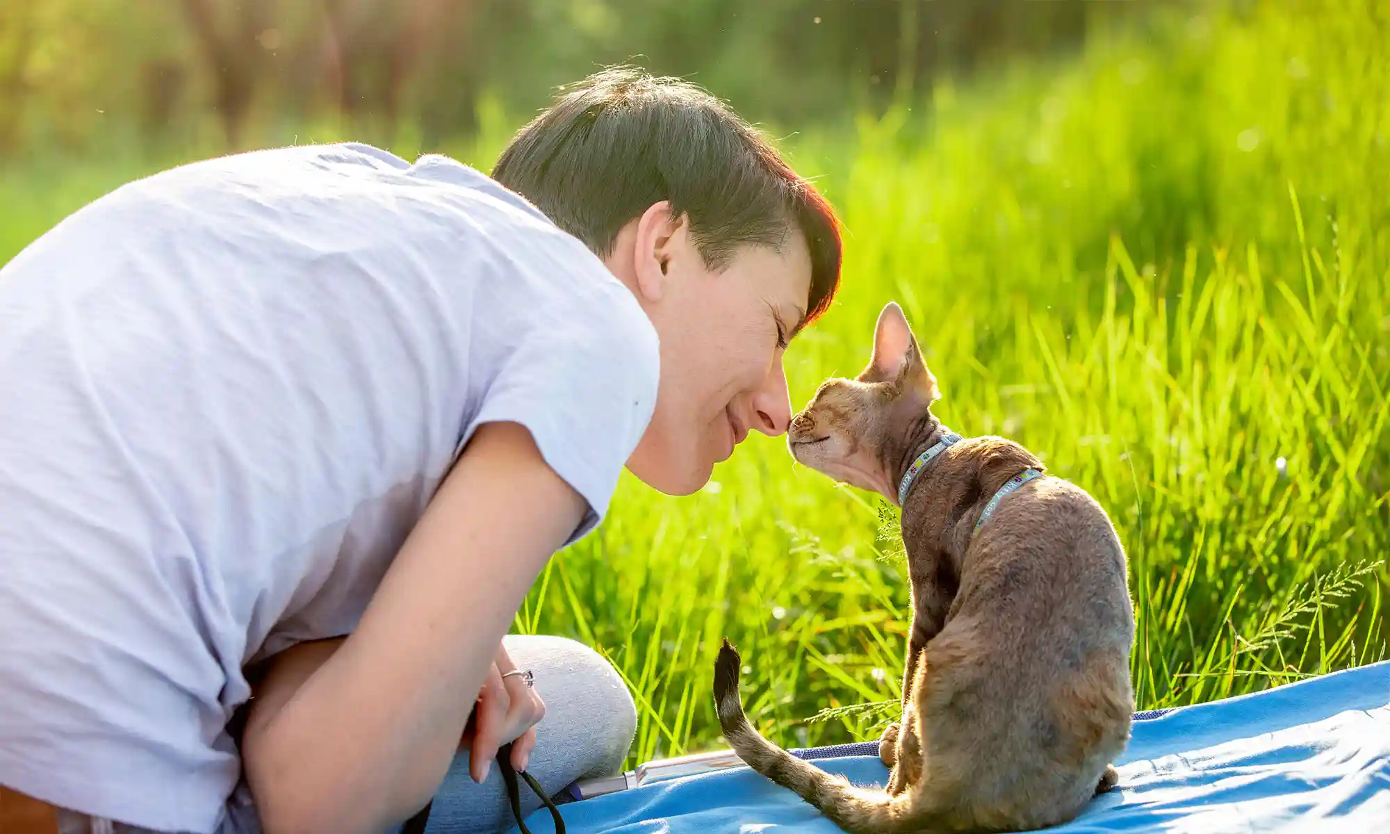 A person with their cat outdoors
